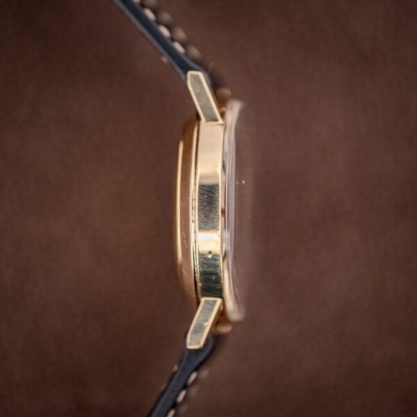 Side profile of the Girard-Perregaux Gyromatic showing the slim gold-filled case band and domed crystal