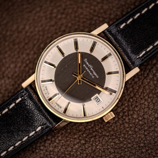 Girard-Perregaux Gyromatic on a black leather strap, gold-filled case and two-tone tuxedo dial viewed at an angle
