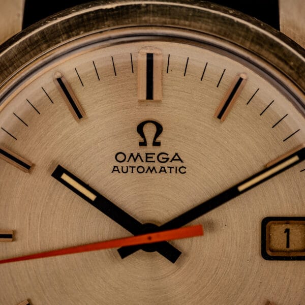Omega Seamaster 166.028 dial close-up showing applied Omega symbol, OMEGA AUTOMATIC text and faceted baton markers