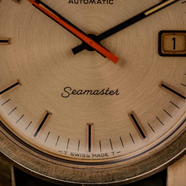 Omega Seamaster 166.028 lower dial with Seamaster script signature and T SWISS MADE T tritium lume marking