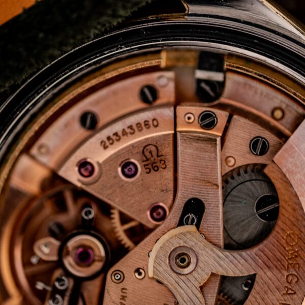 Omega caliber 563 bridge close-up stamped with the Omega symbol, caliber number 563 and serial 25343860