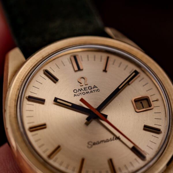 Omega Seamaster 166.028 dial detail, faceted baton markers with dark inlay and the orange seconds hand