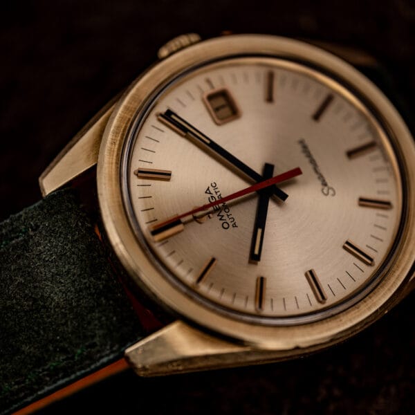 Omega Seamaster 166.028 overhead close view, champagne dial, black baton hands and orange center seconds