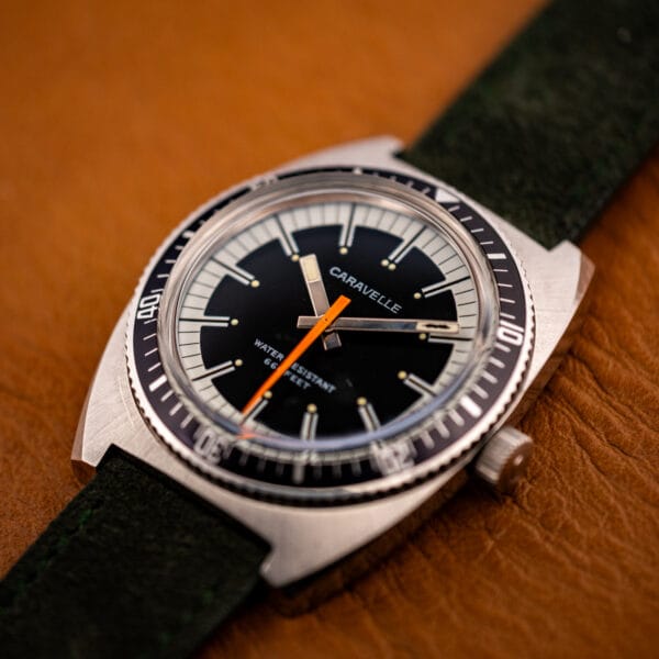 Caravelle Devil Diver 3286-DP cushion stainless steel case angled on forest green Italian suede strap