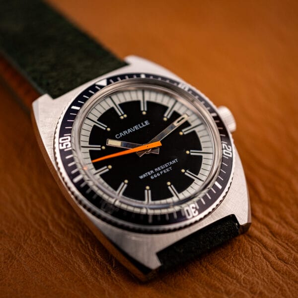 Caravelle 666 Feet diver black starburst dial and steel luminous baton hands on green suede