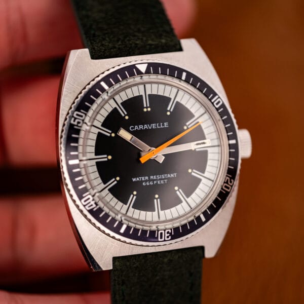 Caravelle Devil Diver dial angled showing fish emblem marker, baton hands and 666 Feet printing