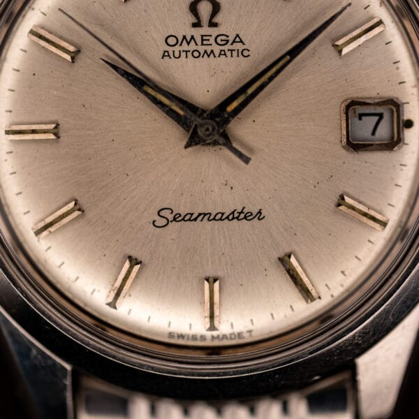 Omega Seamaster 166.010 dial detail with Seamaster script and T SWISS MADE T tritium text above six