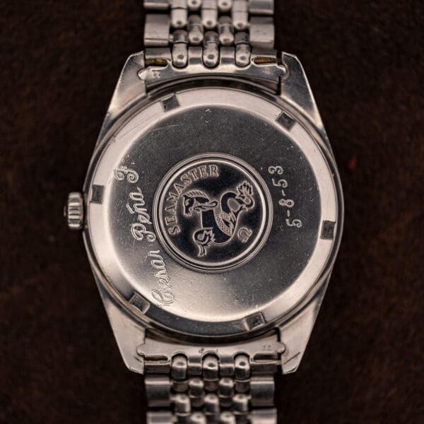Omega Seamaster caseback with embossed seahorse medallion and a previous owner's hand engraving