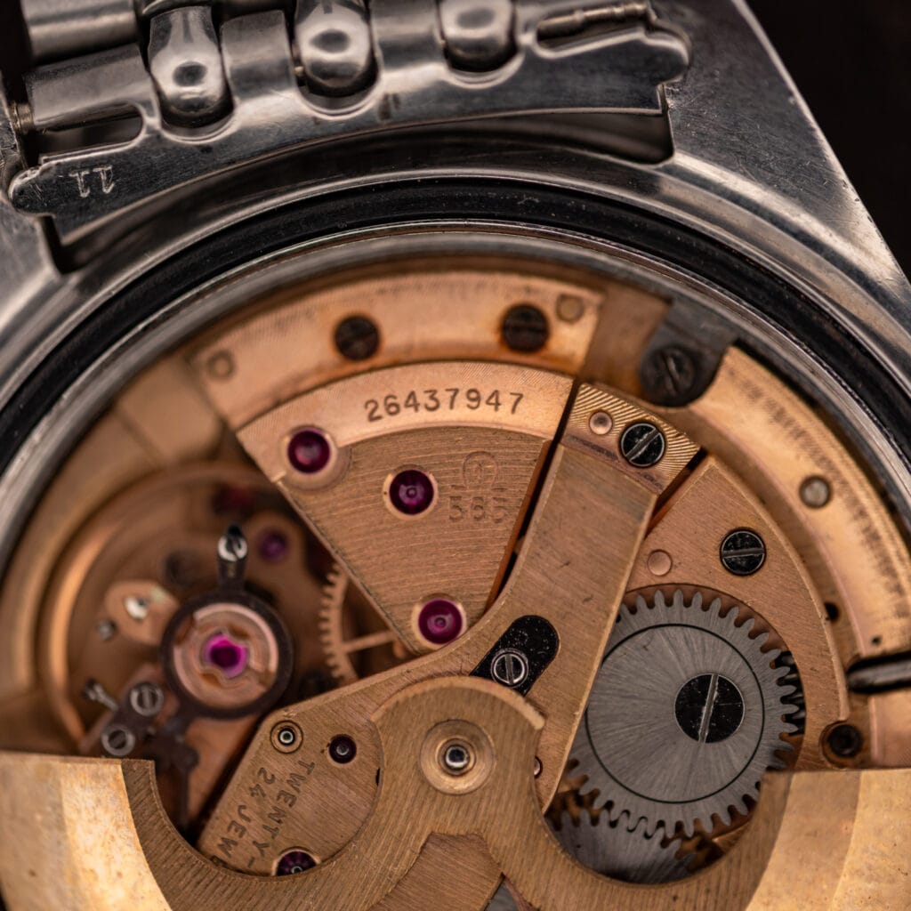 Omega caliber 565 movement detail, balance wheel and bridge stamped 26437947 and 24 jewels