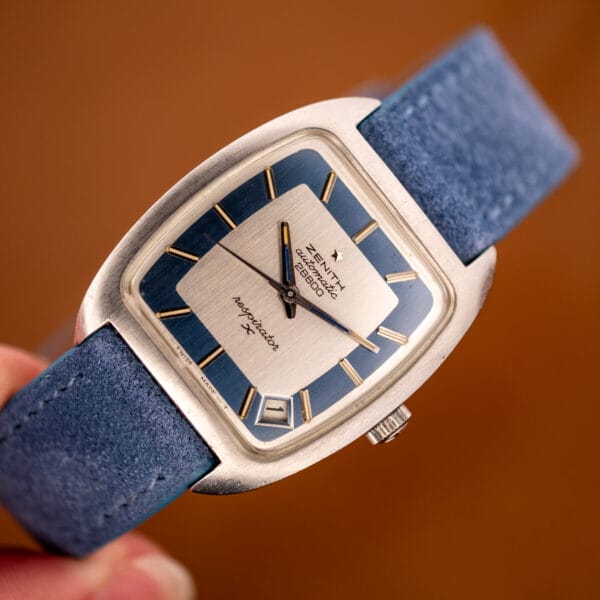 Zenith Respirator X held in hand showing the layered silver and powder-blue dial and tonneau steel case