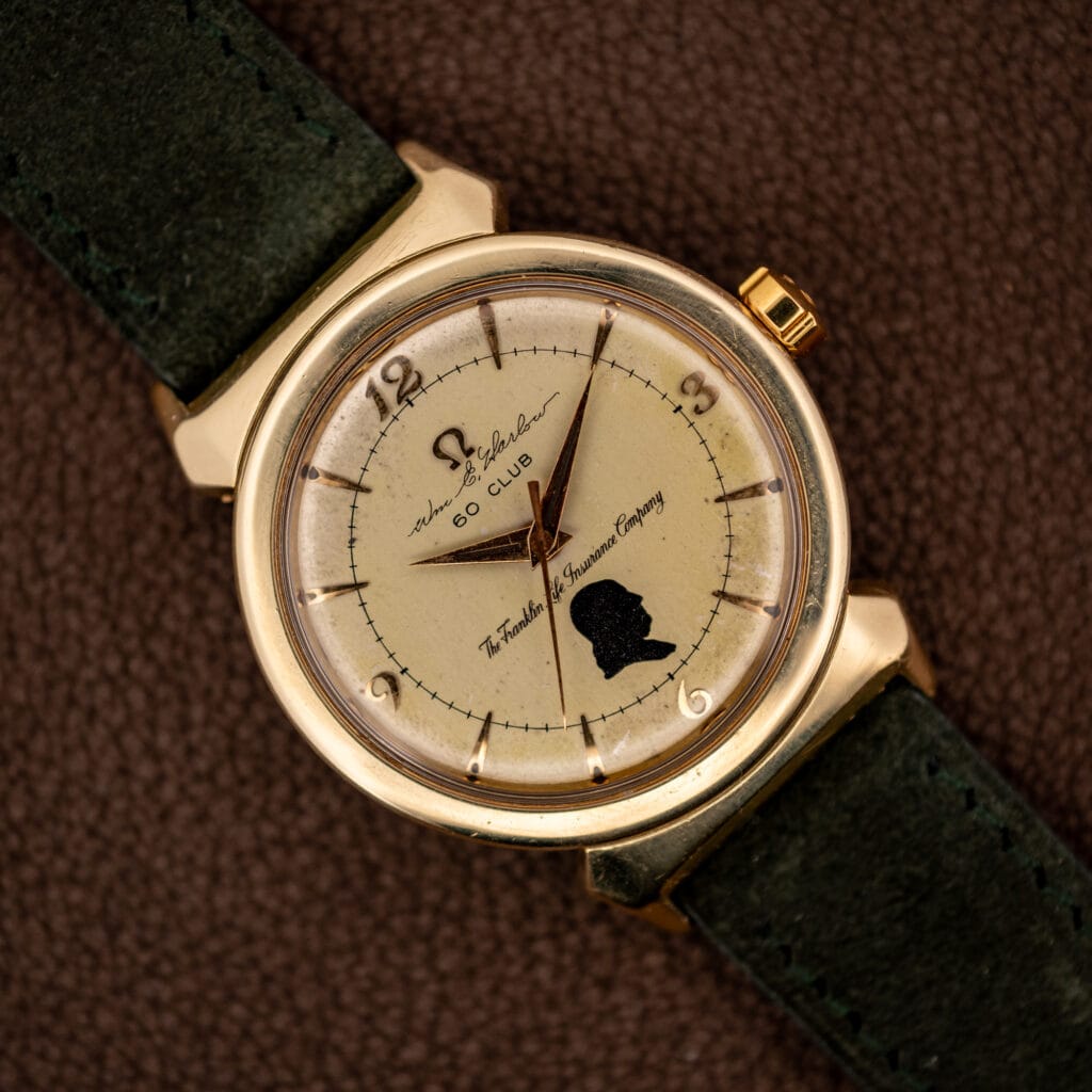 Omega Seamaster 14363-1 SC gold-capped hooded lug case with Franklin Life 60 Club presentation dial on green suede strap