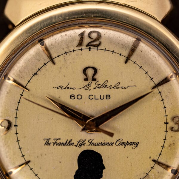 Omega 14363 presentation dial macro showing applied Omega logo, cursive Wm. E. Harlow signature, and 60 CLUB legend
