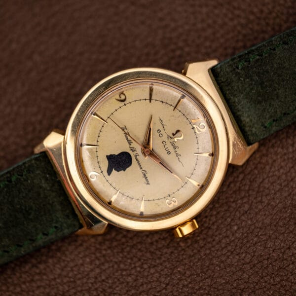 Omega 14363-1 SC top-down view of the Franklin Life Insurance Company presentation dial and gold-capped case