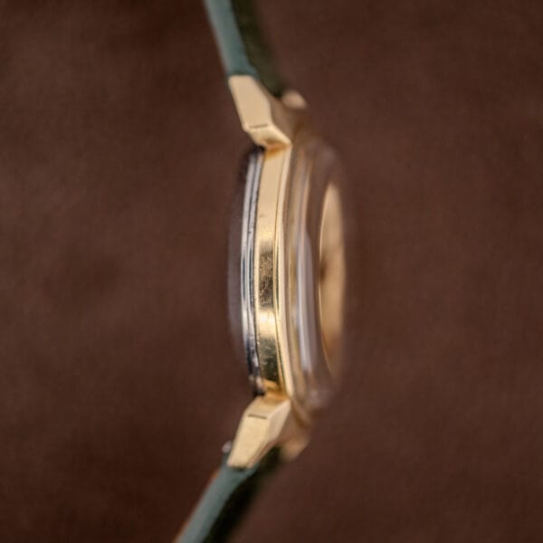 Omega signed crown macro stamped with the Omega symbol on the gold-capped Seamaster 14363 case
