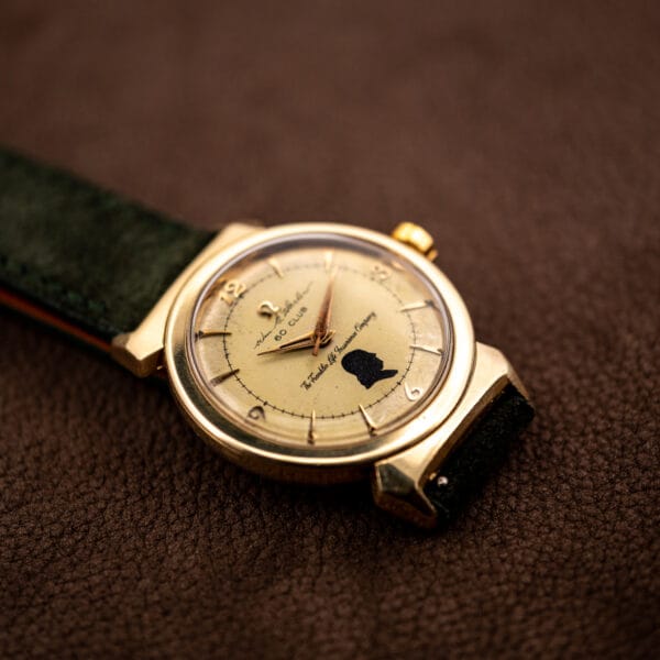 Omega 14363 presentation watch angled view of eggshell dial, Benjamin Franklin silhouette, and gold case