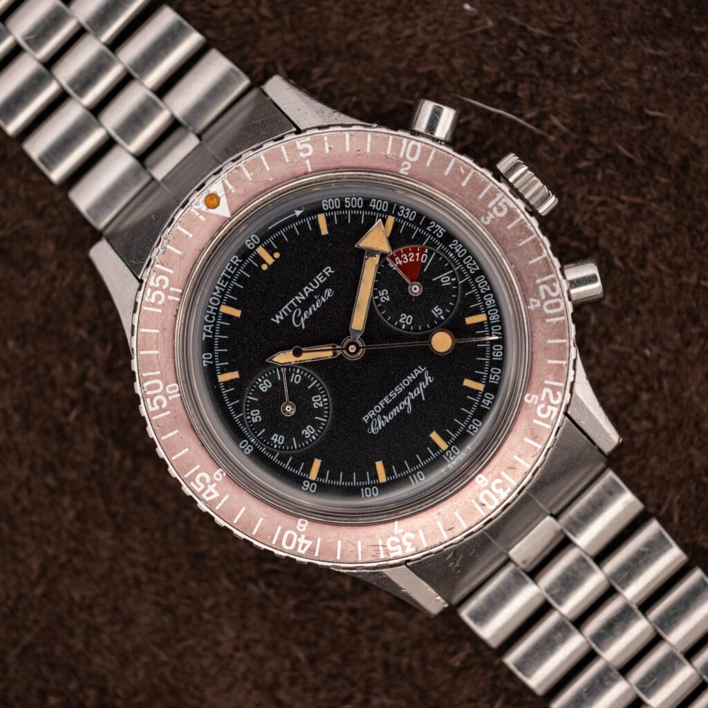 Wittnauer Professional Chronograph 7004A black dial with faded salmon rotating bezel and twin registers on a steel bracelet