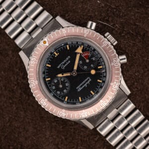 Wittnauer Professional Chronograph 7004A black dial with faded salmon rotating bezel and twin registers on a steel bracelet