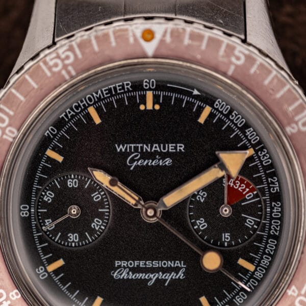 Wittnauer Geneve dial close-up showing red regatta countdown numerals and aged lume at the three o'clock chronograph register