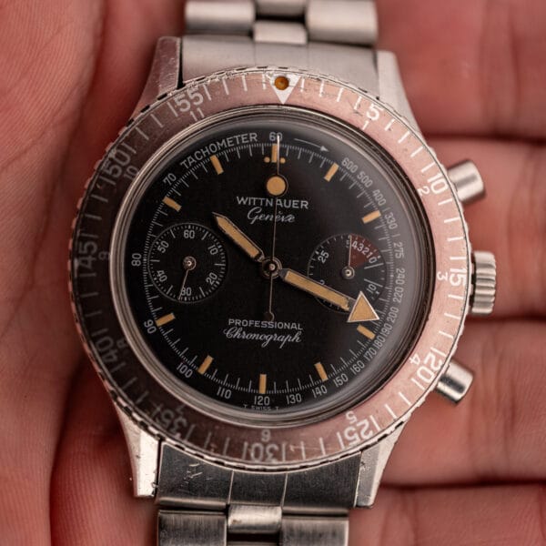 Wittnauer 7004A Professional Chronograph held in hand, black dial with tachymeter scale and twin chronograph registers