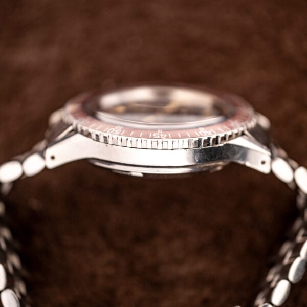 Wittnauer Professional Chronograph case profile with faded burgundy bezel insert and a tall domed acrylic crystal
