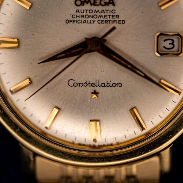 Omega Constellation 168.004 lower dial with Constellation script, applied star, and faceted gold baton hour markers