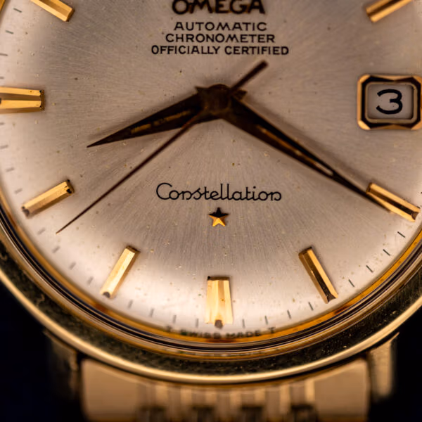 Omega Constellation 168.004 lower dial with Constellation script, applied star, and faceted gold baton hour markers