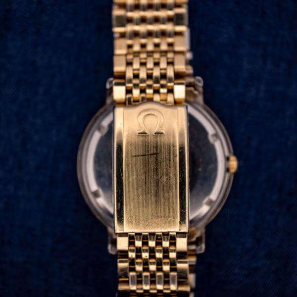 Omega Constellation 14k gold-filled folding clasp with engraved Omega symbol and honest surface wear from use