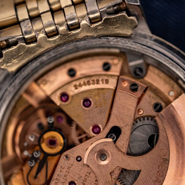 Omega caliber 561 movement close-up showing the 561 caliber stamp, jewels, and Omega signature