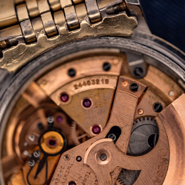 Omega caliber 561 movement close-up showing the 561 caliber stamp, jewels, and Omega signature