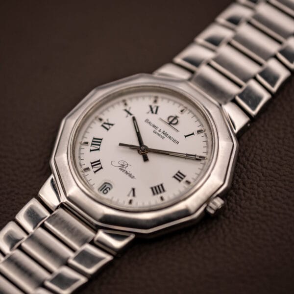 Baume & Mercier Riviera 5131.2 three-quarter view with twelve-sided bezel, white dial and signed crown at three