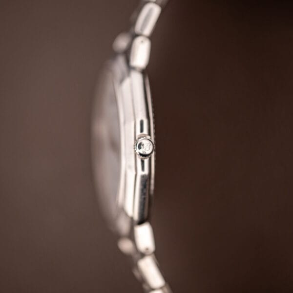 Baume & Mercier Riviera crown signed with the Phi logo, side profile of the slim stainless steel case