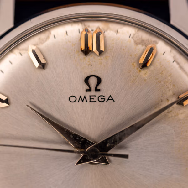 Omega 14772 dial close-up showing applied pink-gold faceted markers and the printed OMEGA name and symbol below twelve