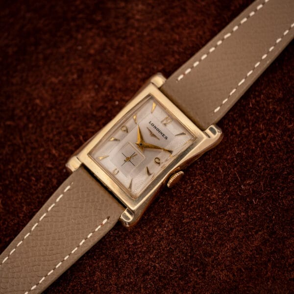Longines 2148-1 angled view showing the sculpted hourglass lugs of the 10k gold-filled tank case