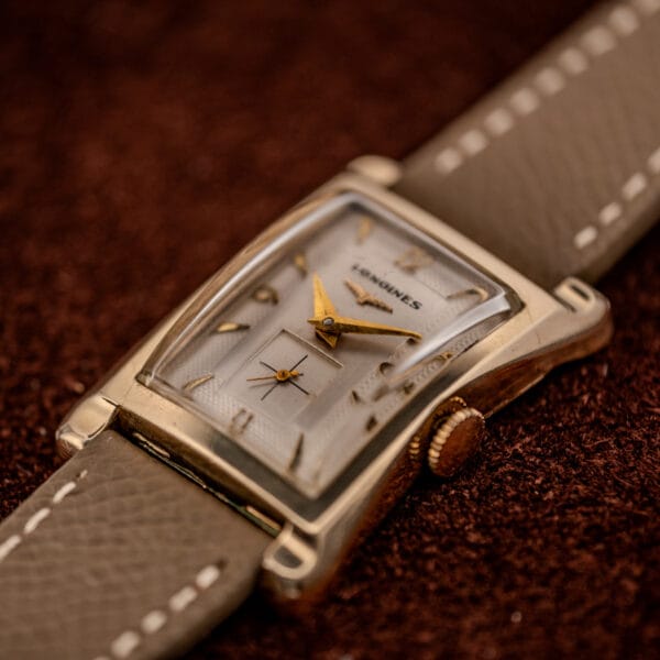 Longines 2148-1 three-quarter view with the domed boxed crystal and signed fluted crown at three