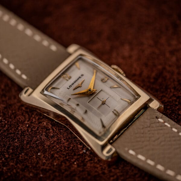 Longines 2148-1 gold-filled tank case profile showing the flared Art Deco lugs and two-tone dial