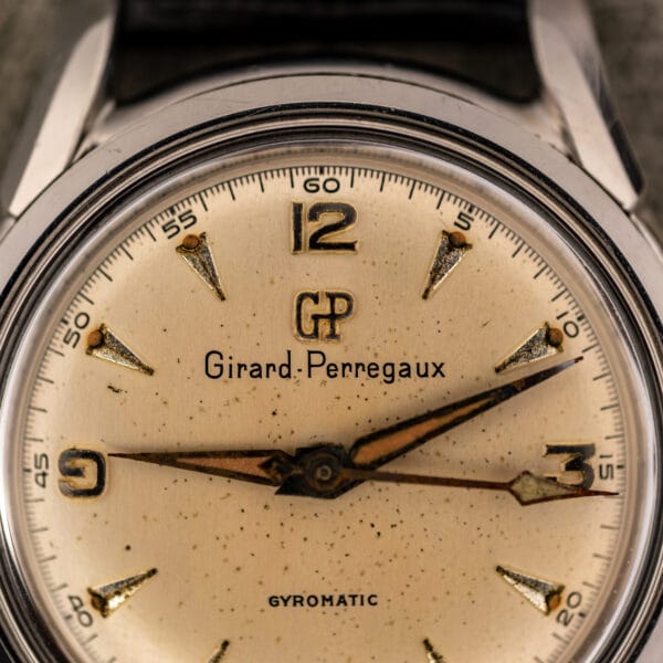 Girard-Perregaux Gyromatic 6170 dial macro showing applied GP monogram, Girard-Perregaux signature and aged leaf hands