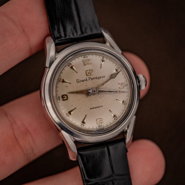 Girard-Perregaux Gyromatic Ref. 6170 held in hand showing modest steel case and cream dial