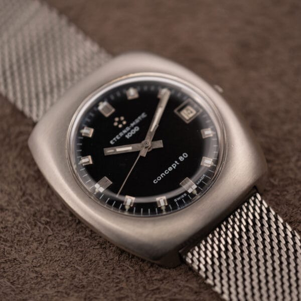 Eterna Matic 1000 Concept 80 black dial under domed acrylic crystal, three-quarter view on mesh bracelet