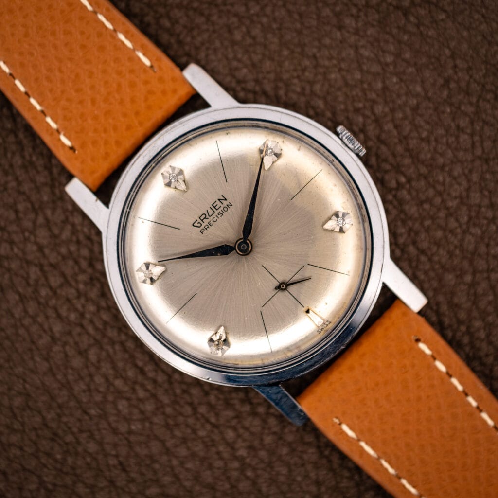 Vintage Gruen Precision diamond sunburst dial wristwatch on honey leather strap, full front view