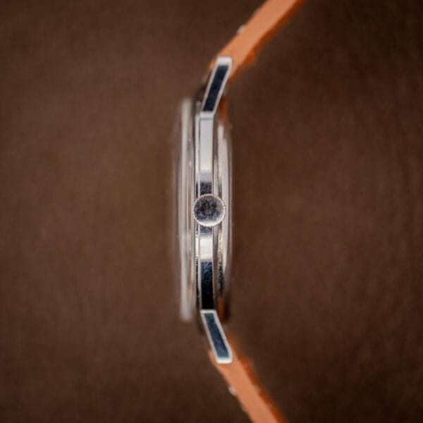 Gruen Precision case side profile showing domed acrylic crystal and small signed crown