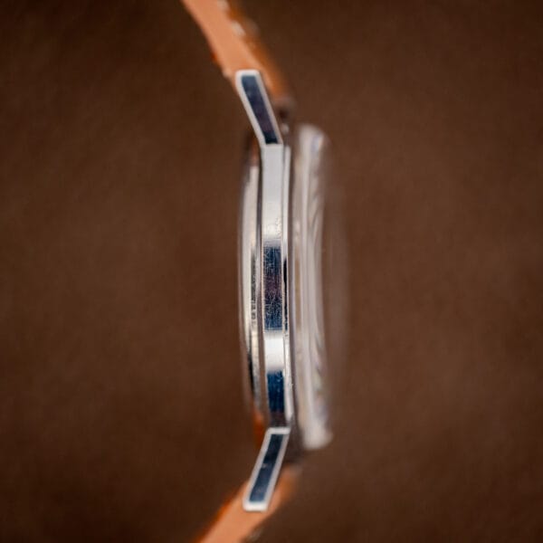 Gruen Precision stainless steel case band side profile with honest surface wear and faceted lugs