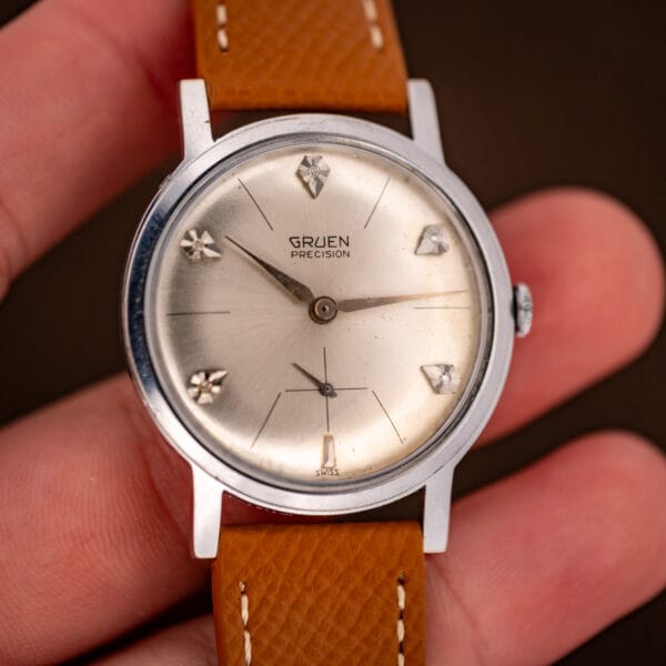 Vintage Gruen Precision diamond sunburst dial held in hand, full dial and signed crown