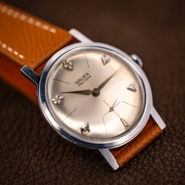 Gruen Precision N510R diamond dial wristwatch on brown leather, angled showing case profile