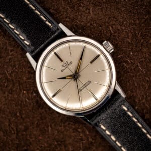 Glycine Compressor ref. 645 silver sunburst dial with applied baton markers and dauphine hands on a black leather strap