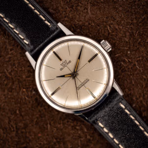 Glycine Compressor ref. 645 silver sunburst dial with applied baton markers and dauphine hands on a black leather strap