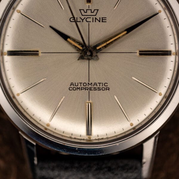 Glycine Compressor dial close-up showing the crown emblem, GLYCINE signature and AUTOMATIC COMPRESSOR text above six