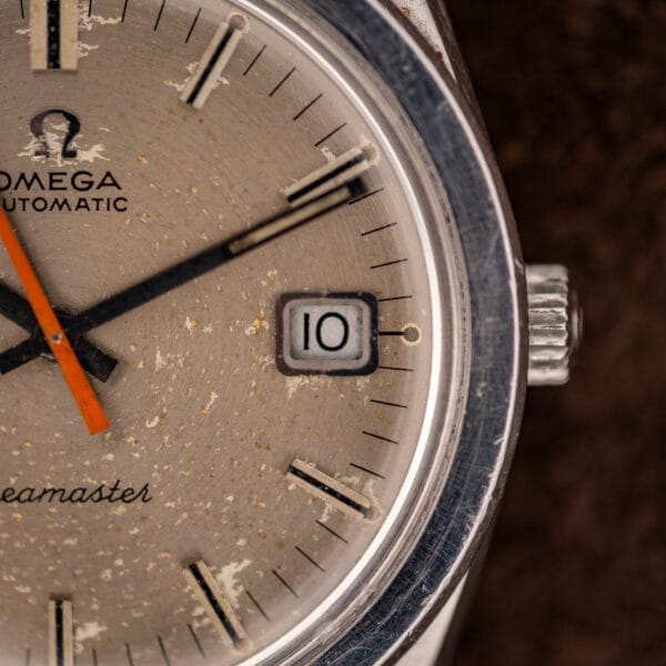 Omega Seamaster 166.028 applied Omega logo above AUTOMATIC with the orange seconds hand crossing a speckled silver dial