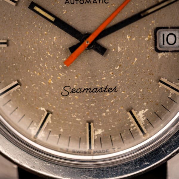 Omega Seamaster 166.028 dial detail with Seamaster script and T SWISS MADE T tritium marking at the foot