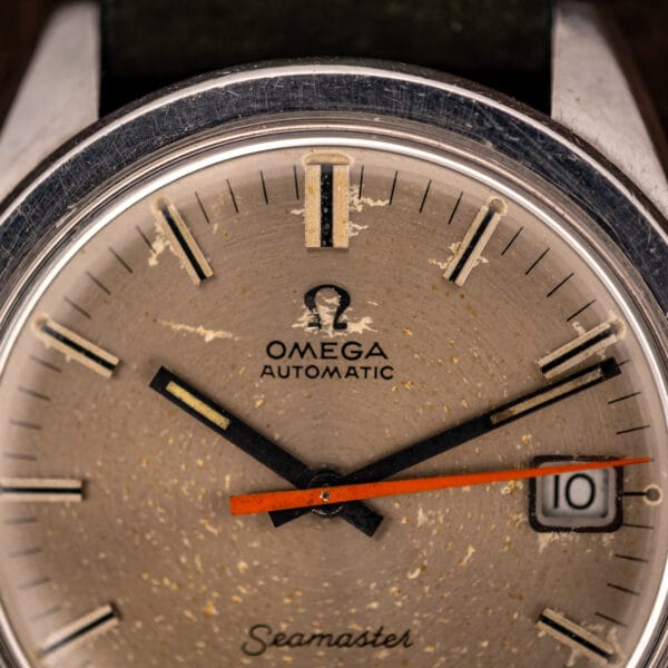 Omega Seamaster 166.028 dial close-up showing applied OMEGA AUTOMATIC printing and the date window at three