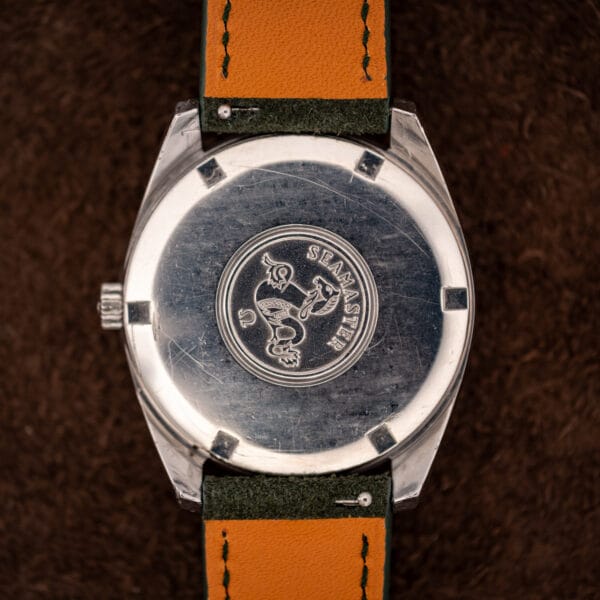 Omega Seamaster 166.028 outer caseback with the raised Seamaster hippocampus seahorse medallion